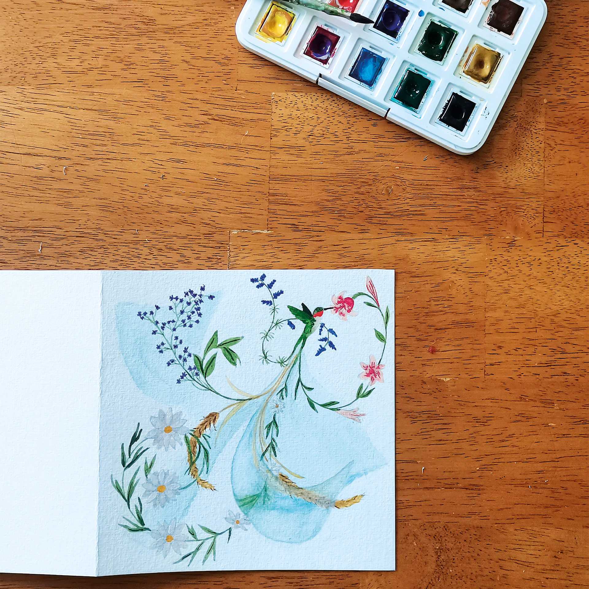 Carte de voeux illustrée à la main à l'aquarelle représentant un colibri